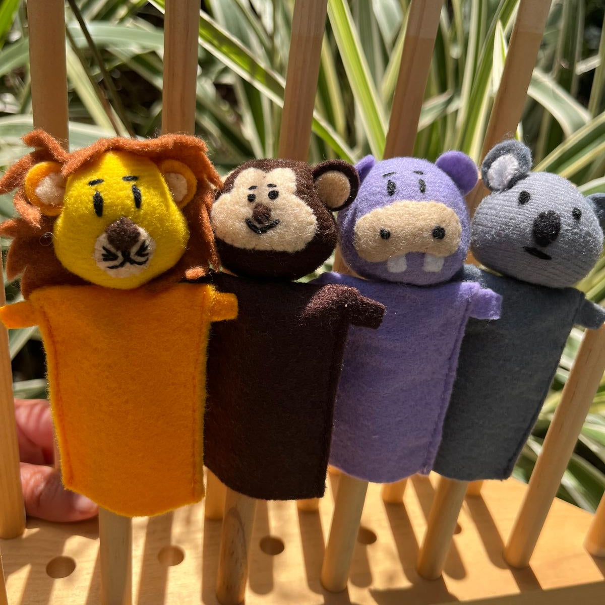 Set of four jungle finger puppets including a lion, monkey, hippo, and koala, handmade.