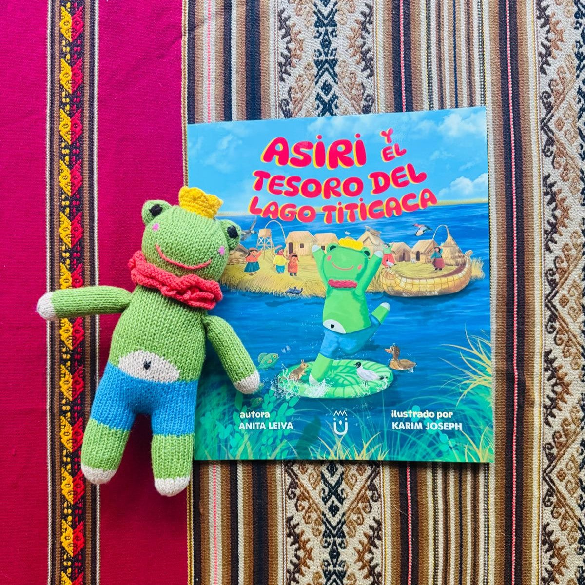Asiri handcrafted frog doll paired with the illustrated children's book Asiri and the Treasure of Lake Titicaca, Spanish edition