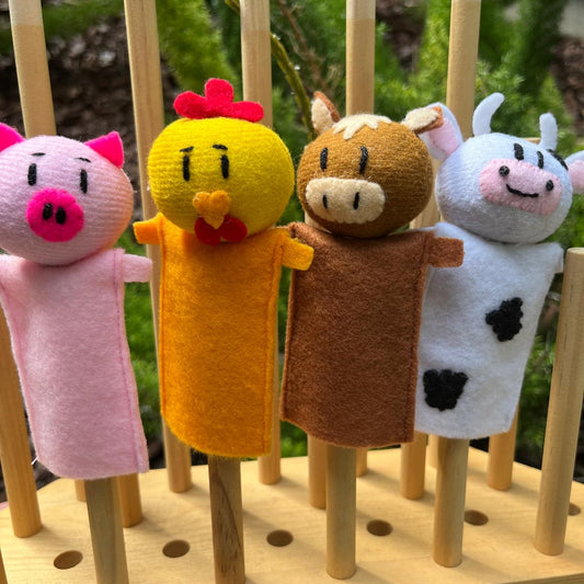 Set of four handmade farm finger puppets including pig, horse, chicken, and cow, made with colorful felt.